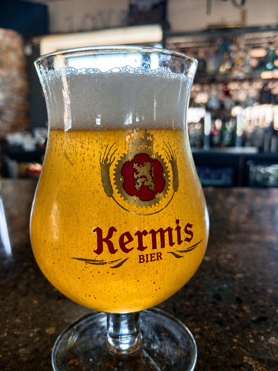 Golden Kermis Blond served with a creamy head in its branded glass